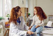 © Studio Romantic - Little patient at neurologist's appointment. Female doctor taps little girl on knee with special hammer to check her reflexes. Kid visits doctor during regular medical examination.