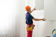 © Angelov - repairman installs furniture in the children's room