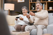 © C Daniels/peopleimages.com - Video game, sofa and senior couple with gaming online in home for happy holiday, retirement and lifestyle together with technology. Excited, elderly and gamer people on a couch with living room games