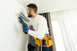 © Angelov - Male technician cleaning air conditioner indoors