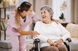 Healthcare, support and caregiver with senior woman for medical help, elderly care and consulting patient. Wheelchair disability, rehabilitation and nurse volunteer at nursing home for charity work