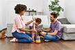 © Krakenimages.com - Couple and daughter smiling confident playing with toys sitting on the floor at home