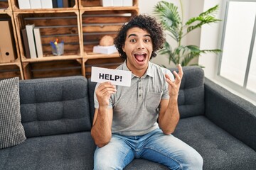 Sticker - Hispanic man with curly hair asking for help celebrating victory with happy smile and winner expression with raised hands