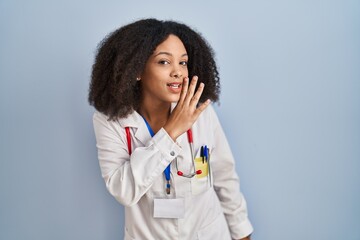 Wall Mural - Young african american woman wearing doctor uniform and stethoscope hand on mouth telling secret rumor, whispering malicious talk conversation
