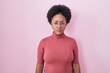 © Krakenimages.com - Beautiful african woman with curly hair standing over pink background skeptic and nervous, frowning upset because of problem. negative person.