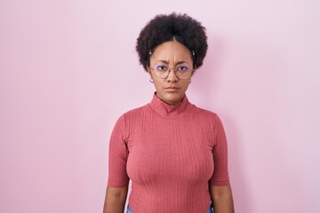 Sticker - Beautiful african woman with curly hair standing over pink background skeptic and nervous, frowning upset because of problem. negative person.