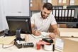 © Krakenimages.com - Young hispanic man smiling confident writing on notebook at storehouse
