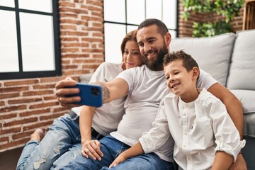 Wall Mural - Family make selfie by smartphone sitting on floor at home