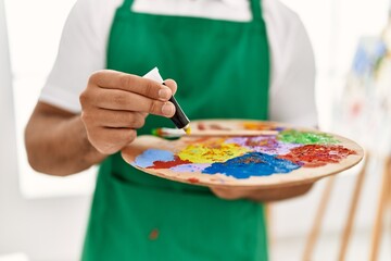 Poster - Young hispanic man mixing color at art studio