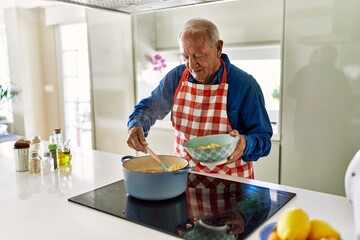 Poster - Senior man smiling confident cooking spaghetti at kitchen