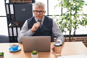 Sticker - Middle age grey-haired man business worker using laptop with doubt expression at office