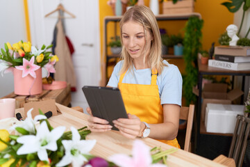 Sticker - Young blonde woman florist smiling confident using touchpad at flower shop