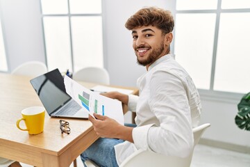 Wall Mural - Young arab man using laptop working at office