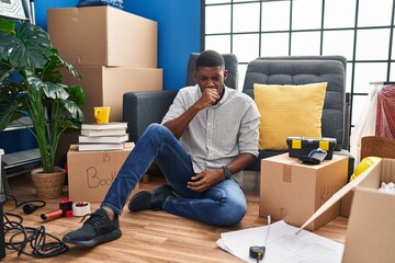 Wall Mural - African american man sitting on the floor at new home feeling unwell and coughing as symptom for cold or bronchitis. health care concept.