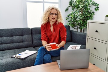 Canvas Print - Middle age psychologist woman at consultation office clueless and confused expression. doubt concept.