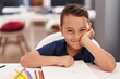 © Krakenimages.com - Adorable hispanic toddler student smiling confident sitting on table at classroom