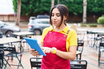 Poster - Young beautiful arab woman waitress smiling confident using touchpad at coffee shop terrace