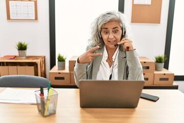 Canvas Print - Middle age grey-haired call center agent woman smiling happy working at the office.