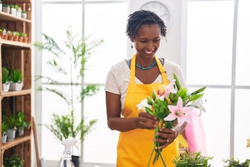 Poster - Middle age african american woman florist holding bouquet of flowers at flower shop