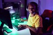 © Krakenimages.com - African american woman streamer playing video game using computer at gaming room