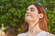 © Krakenimages.com - Young woman smiling confident breathing at park