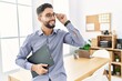 © Krakenimages.com - Young arab man smiling confident holding clipboard at office