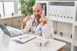 © Krakenimages.com - Young bald man with beard working on telephone appointment pointing finger to one self smiling happy and proud