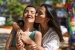 © Krakenimages.com - Two women mother and daughter hugging each other kissing at park