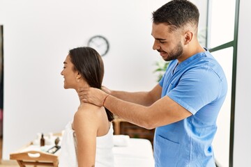 Sticker - Latin man and woman wearing physiotherapy uniform having rehab session massaging neck at beauty center