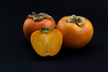 Natural and Organic Kaki fruit (Turkish: persimmon) on black background