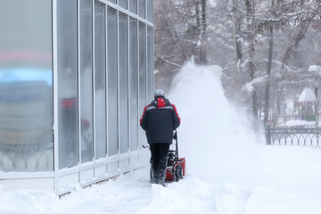 Wall Mural - A portable snow blower powered by gasoline. Snow removal in winter.