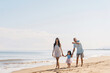 © Djavan Rodriguez - Latin american young family together walking on the beach.
