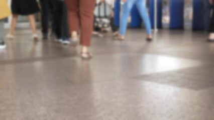 Wall Mural - defocused blurred low angle view to feet with crowd of people moving travel on the transition to the