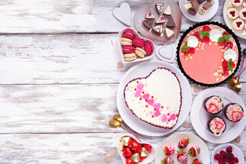 Leinwandbilder - Valentines Day side border with a selection of desserts and sweets. Top down view over a white wood background. Love and hearts theme. Copy space.