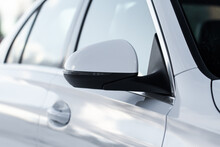 Close Up Front View Of Car Side Mirror. Front Rear View Mirror On The Car Window. White Car Exterior Details.