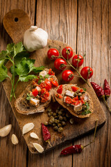 Wall Mural - italian bruschetta with hot chili peppr caper garlic and oregano