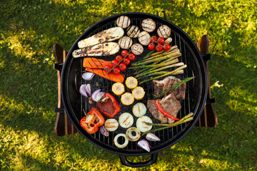 Wall Mural - Delicious grilled vegetables and meat on barbecue grill outdoors, top view