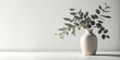 Green eucalyptus leaves in ceramic vase on white table. Front view, empty wall background. Place for text, copy space, empty space. Generative AI