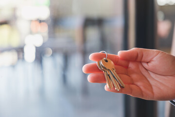 Wall Mural - Closeup image of a hand holding the keys for real estate concept