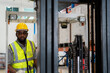 © 2B - Two African workers working in a warehouse Organize the product system with a forklift truck. transportation industry.