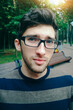 © yurolaitsalbert - young man with glasses standing in the street and looking at the