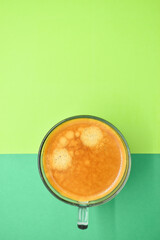 Wall Mural - glass of hot black coffee put on green background