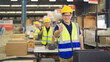 © tampatra - Teamwork group of Asian man worker working in large warehouse retail store industry factory. Rack of stock storage. Cargo in ecommerce and logistic concept. Depot. People lifestyle. Shipment service.