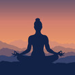 © MoonS  - Silhouette of a woman in lotus pose meditating at sunrise