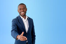 African Businessman Stretching Out Hand To Shake, Empty Blue Background