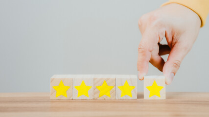 Poster - Customer's hand selects a star icon on a wooden cube block with 5 Star Satisfaction. Best great business services rate the customer experience. Satisfaction Survey Concept.