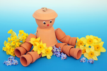 recycled flowerpot man garden ornament with spring cowslip, daffodil and forget me not flowers. whim