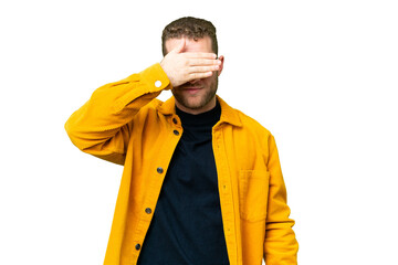 Wall Mural - Young handsome blonde man over isolated chroma key background covering eyes by hands. Do not want to see something