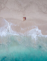 Wall Mural - Drone aerial view at couple on the beach at Freedom beach in Phuket Thailand during vacation, top view at tropical beach with people on the beach