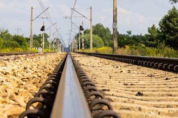 Railway track rails on a hot summer day. Super low angle perspective shot